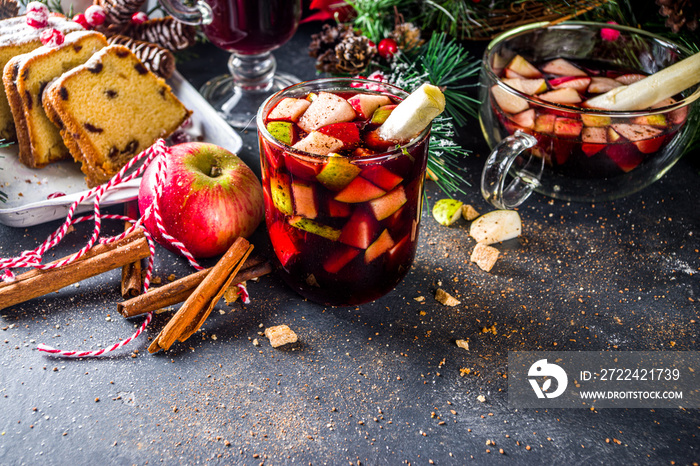 Festive winter fruit punch or sangria drink. Christmas mulled red wine. Ponche de frutas Navideño cocktail, Mexian Christmas hot  beverage with sugar cane and fruit, hot sweet liquor wine drink