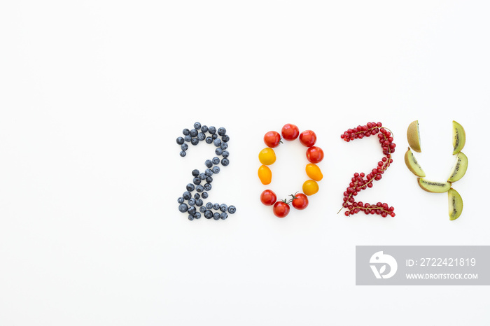 New year 2024 made of fruits on the white background. Healthy food