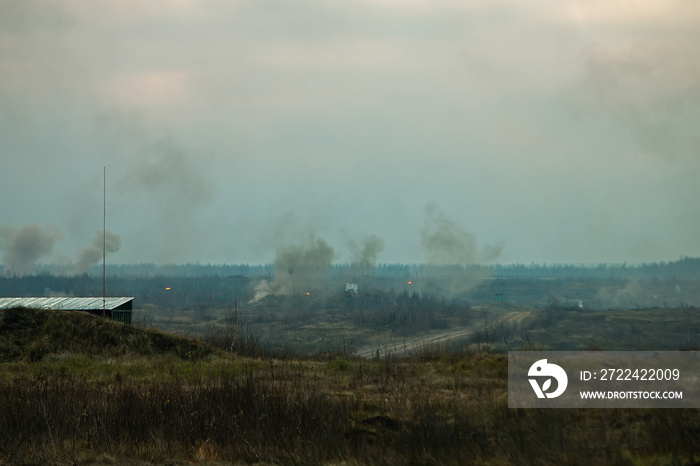 Hostilities. War concept. Military training ground with the explosions.