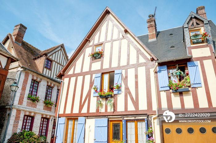 Typical timber-frame houses with blue shutters in picturesque village La Bouille in Upper Normandy region, France