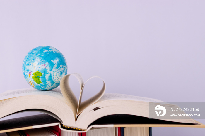 World Teacher’s Day. Globe and book an open book over white background.