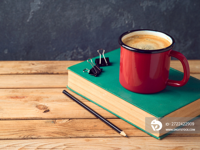 Coffee cup and old book