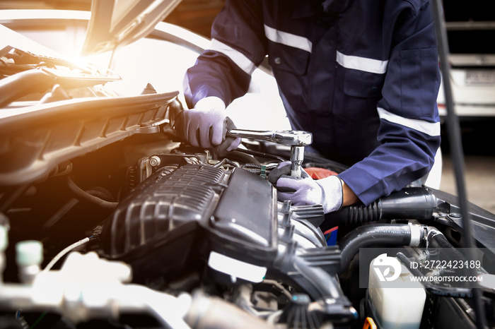 Auto mechanic working on car engine in mechanics garage.Repair service,car service, repair, maintenance concept.