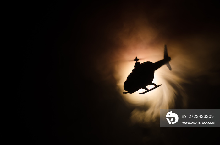 Helicopter over fire sunset horizon. War concept. Military scene of flying helicopter fire backgroung effect. Decoration