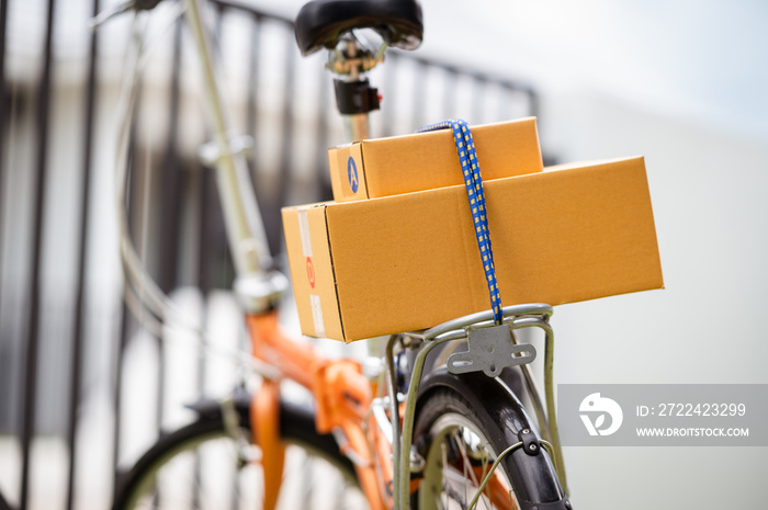 Closeup Delivered package parcels box on bicycle outdoors to deliver.
