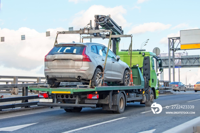 Hatchback car loaded onto a tow truck ready for transport.