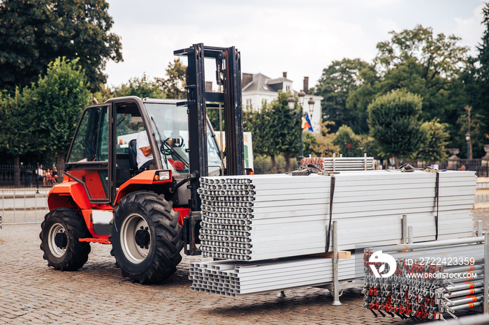 Forklift delivers metal profile from warehouse for construction of building