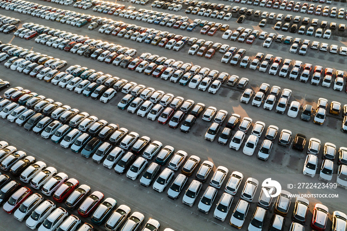 Aerial view new cars lined up in the parking station for import and export business logistic to dealership for sale, Automobile and automotive car parking lot for commercial business industry.