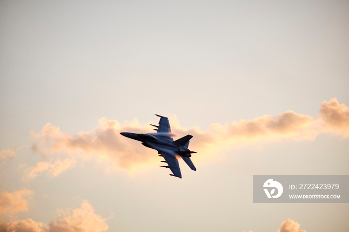 Australian Air Force fighter jet flying through Brisbane at sunset