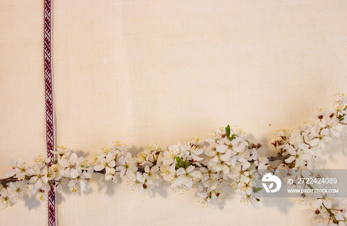 Latvian National Festive Decoration with Cherry Blossom Branch from the Ribbon of Latvian Symbols of the Latvian Independence Day Belt