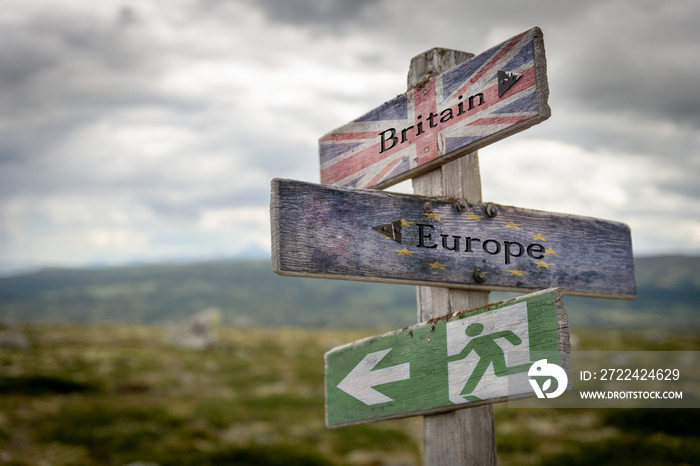 Britain, europe and exit text with flag on wooden signpost outdoors in nature, emergency sign to symbolize Brexit..Politics and country concept.