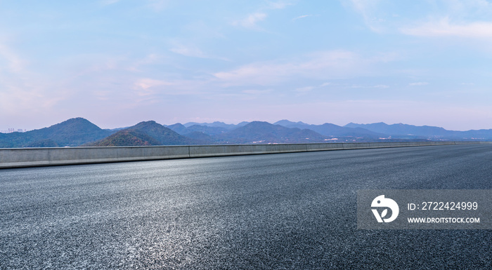 Asphalt road and mountain natural scenery at dusk