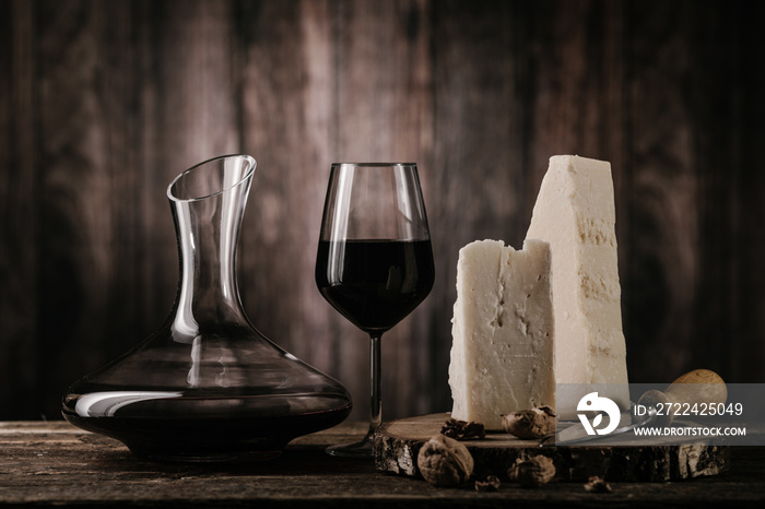 Cheese and wine on old wooden table