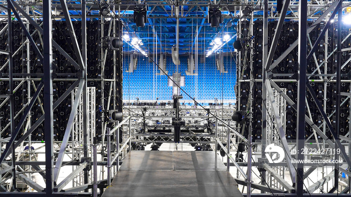 Installation of equipment and spotlights for stage. Stock footage. Preparing stage with bleachers and professional equipment and floodlights before performance or competition