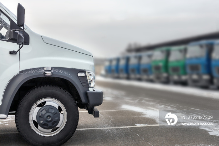 New middle size trucks at dealership parking outdoors at winter. Truck service and maintenance. Delivering and warehouse service