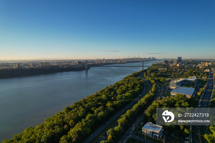 An aerial shot of the Hudson river with the George Washington Bridge in the distance