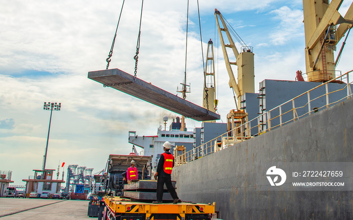 plate of steel slab being lifting by the ship crane, loading discharging operation for transfer the cargo shipment in export and import, works by stevedore labor in charge on jetty port terminal