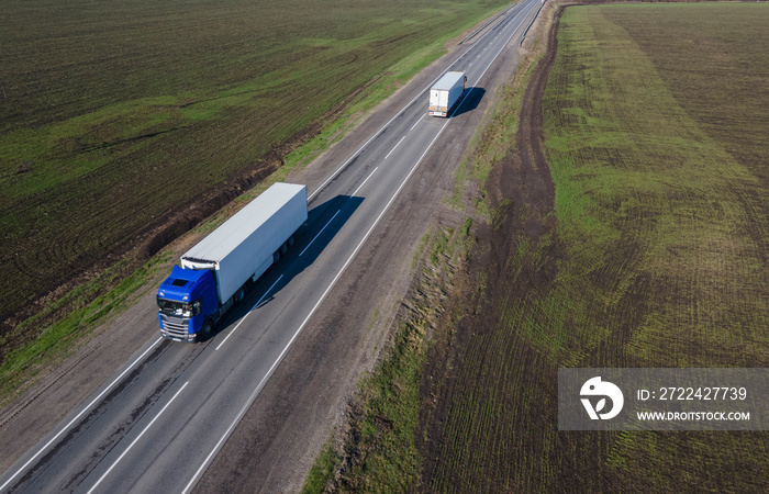 Two Truck with Cargo Semi Trailer Moving on Rural Road in Direction. Aerial Top View