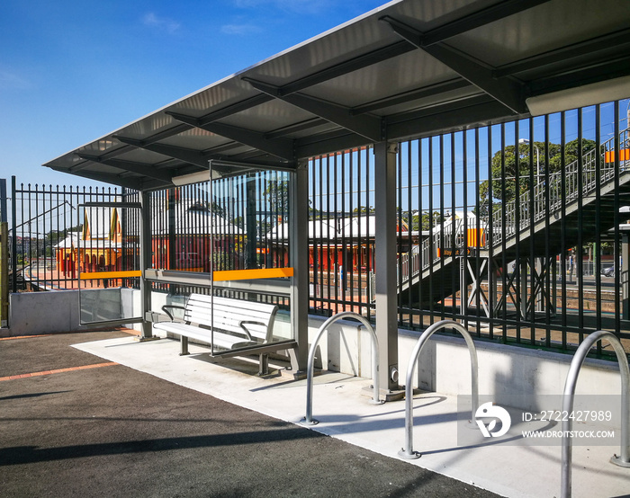 A bus stop with an aluminum bench and bicycle parking area in Sydney, Australia.