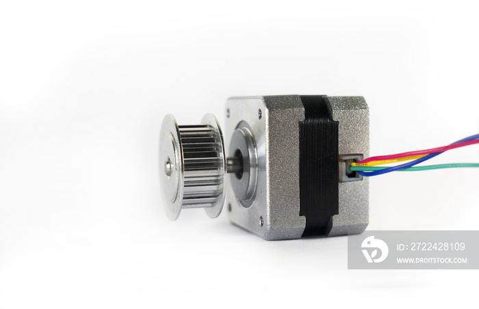 Electric stepper motor with a shiny metal timing pulley mounted to the shaft is laying down on its side ready to be used in a mechanical engineering or hobby robotics project.