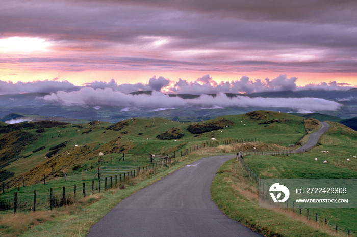 Wales, Powys, near Machynlleth, storm cloud sunset, winding road