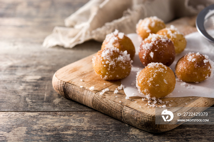 Carnival fritters or buñuelos de viento for holy week on wooden table. Copy space