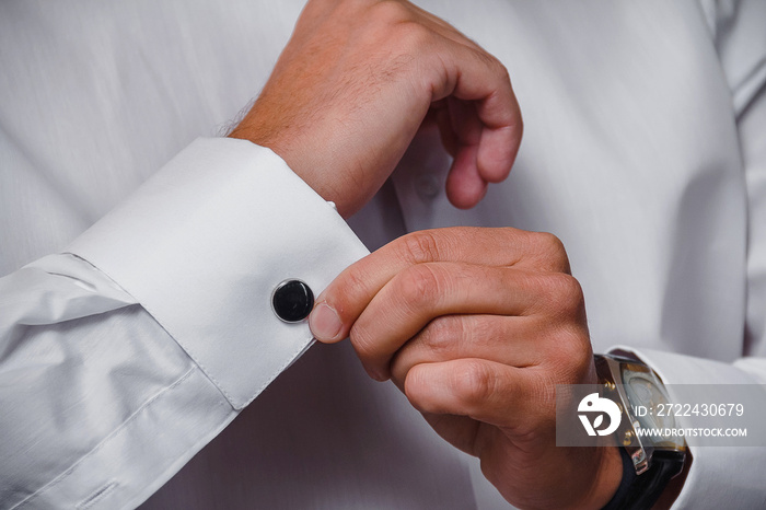 close up of a hand man wears white shirt and cufflink