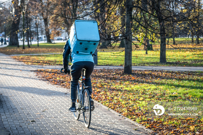 Rider with bike delivering food, online food ordering and delivery service that takes orders via a mobile app during Covid or Coronavirus time