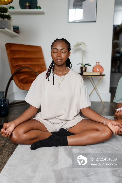 Young woman practicing yoga at home