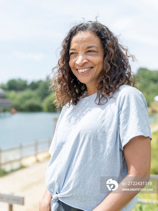 Portrait of smiling woman looking at lake