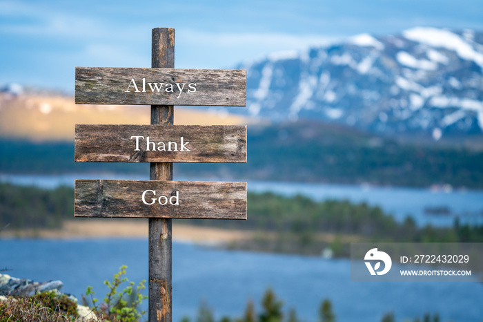 always thank god text quote on wooden signpost outdoors in nature during blue hour.