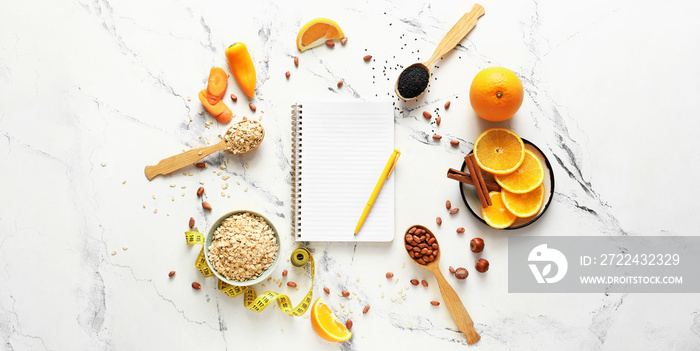 Healthy products and blank notebook on light background. Diet concept