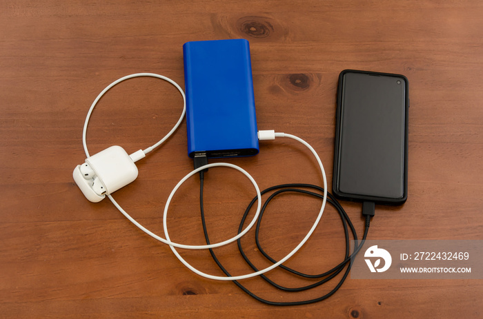 Charge sharing: recharging a cellphone and air pods with a power bank