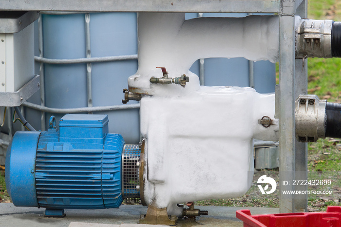 electric motor and industrial pump  ice covered   in refrigeration plant