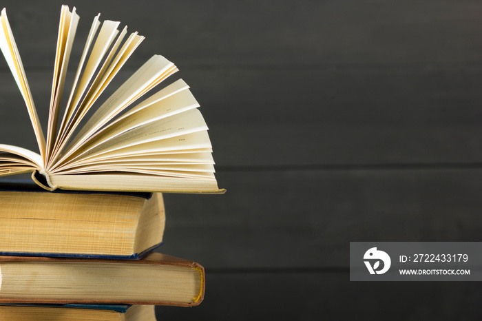 Open book, hardback books on wooden table. Back to school. Copy space