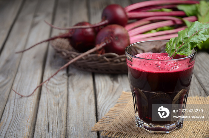Fresh beetroot juice on wooden background, selective focus, copy space