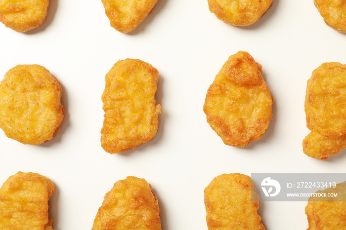 Flat lay with fried chicken nuggets on white background