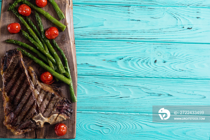 Grilled T-bone steak with asparagus and cherry tomatoes