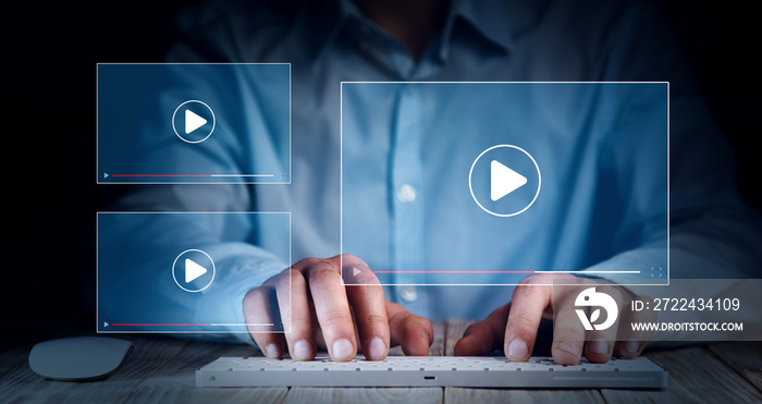 man working on laptop, watching video player