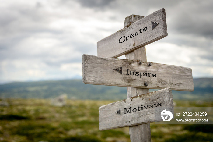 create inspire motivate text quote on wooden signpost outdoors in nature.