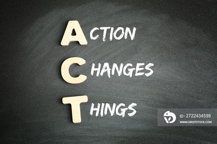 Wooden alphabets building the word ACT - Action Changes Things acronym on blackboard