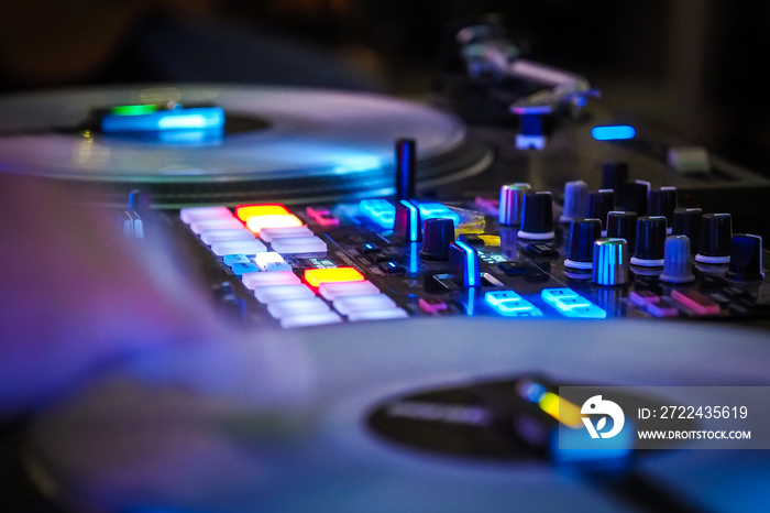 DJ vinyl players in dark nightclub, party in the dance club, DJ equipment, defocused