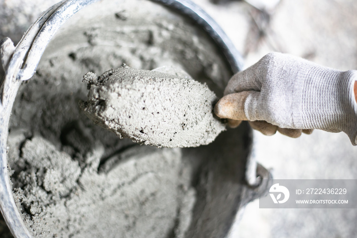 Cement or mortar, Cement powder with a trowel put on the brick at construction work.