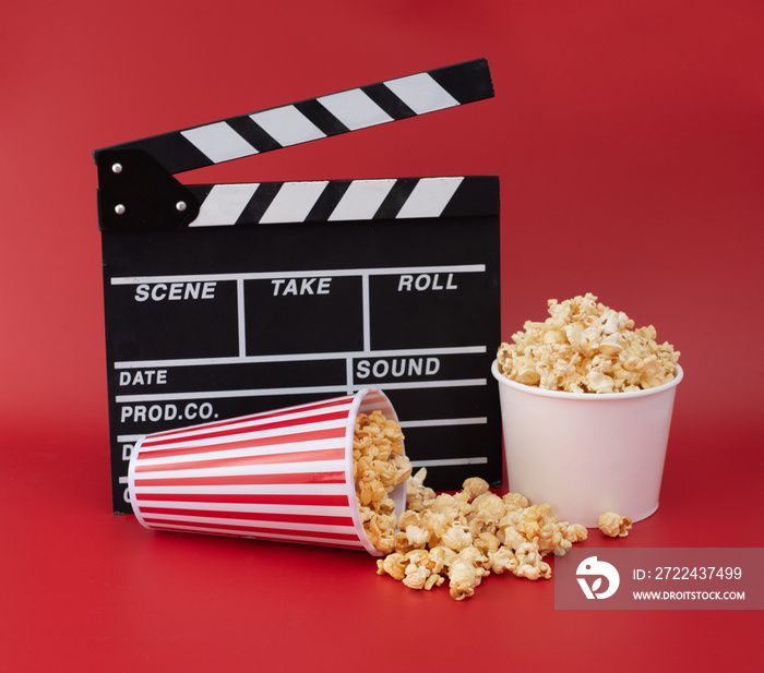 Clapper board with popcorn against red background,Cinema minimal concept