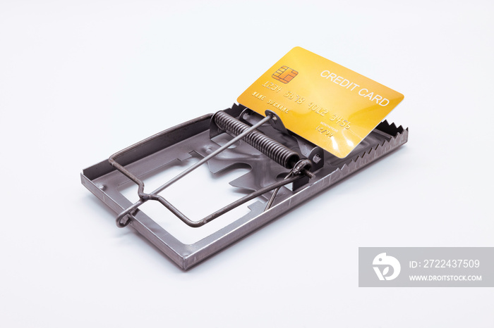 Yellow credit card placed on a mousetrap, Financial trap, Indebtedness, Financial problems.