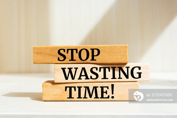 Wooden blocks with words ’Stop wasting time’. Business concept