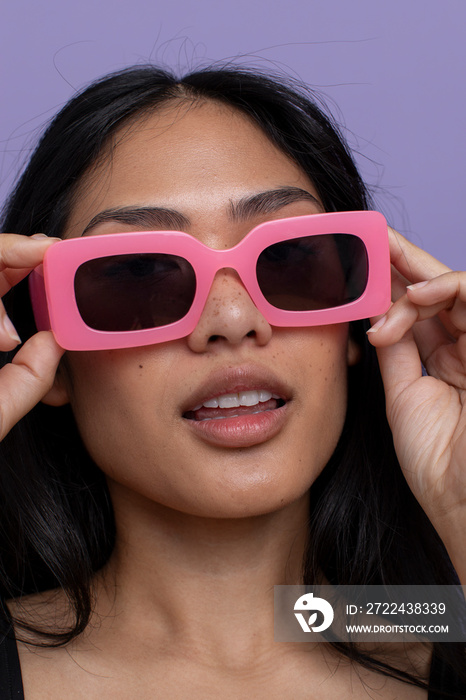 Portrait of woman wearing pink sunglasses