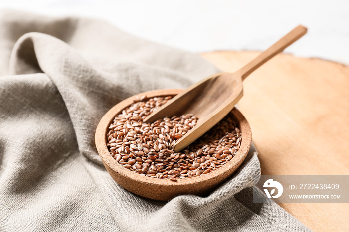 Plate and scoop with flax seeds on table