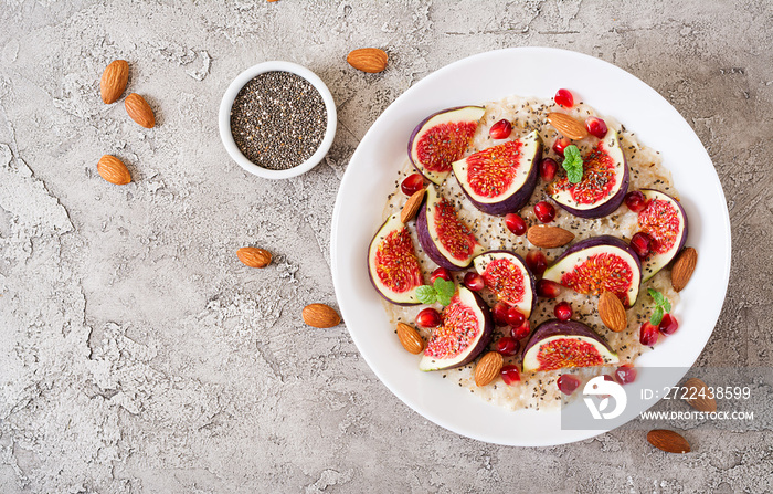 Delicious and healthy oatmeal with figs, almond and chia seeds. Healthy breakfast. Fitness food. Proper nutrition. Flat lay. Top view.