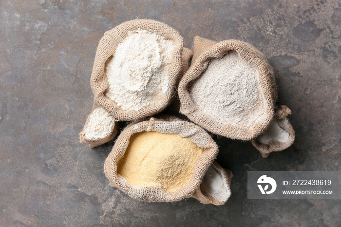 Bags with different flour on grunge background